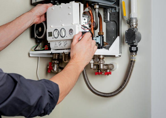 hands of HVAC technician performing boiler repair services